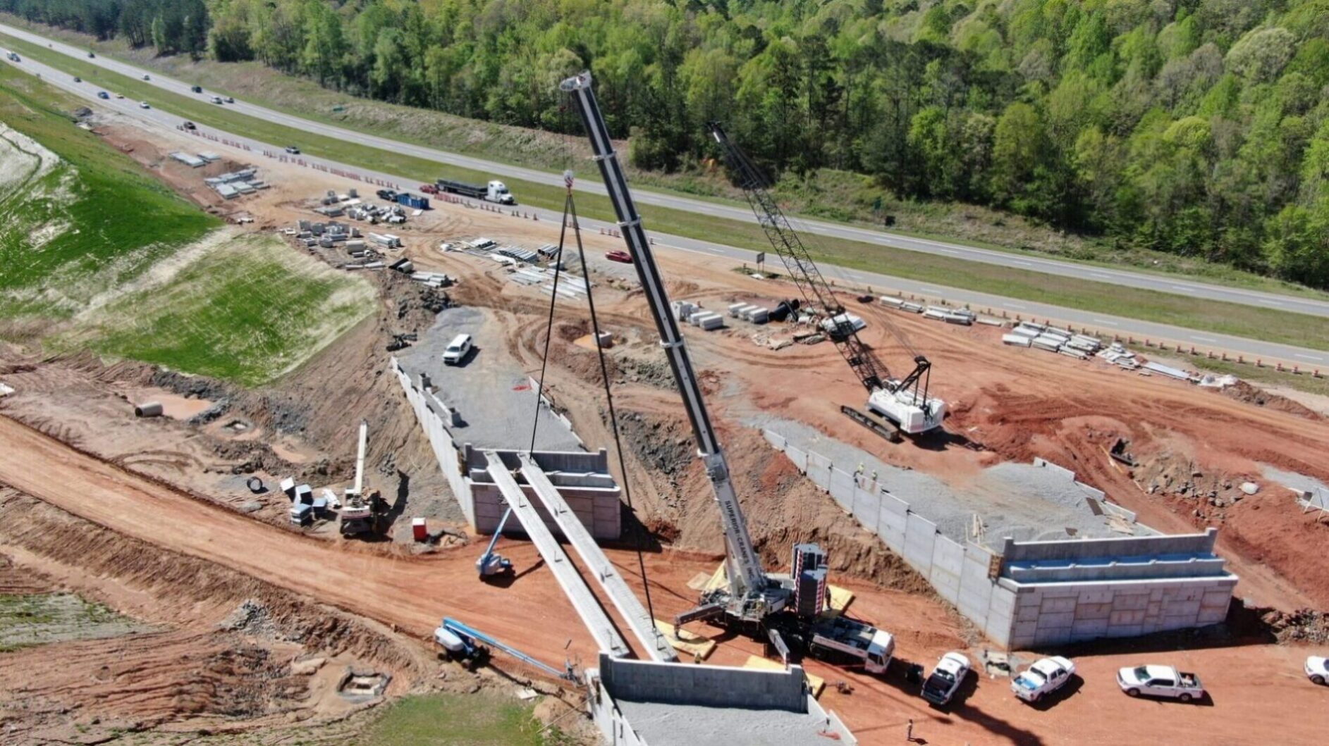 Aerial bridge construction site with mobile cranes
